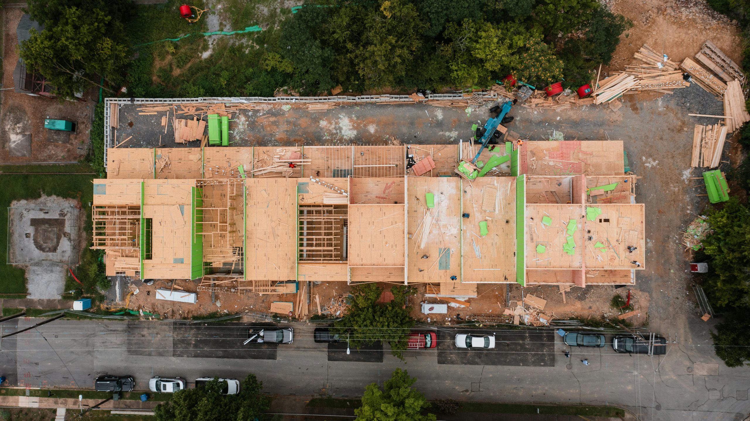 Aerial shot of a construction site in Chattanooga, showcasing wooden framework and heavy machinery.